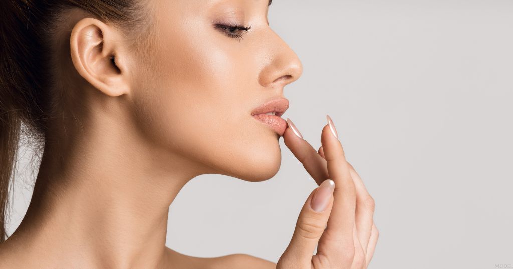 Woman touching her lips (MODEL)