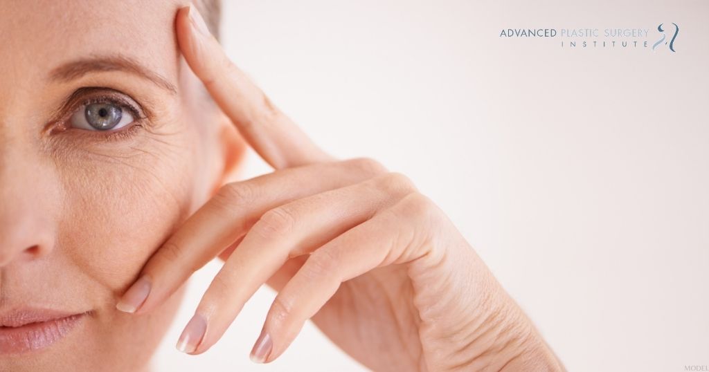 a person looking at the camera with their hand on their face (MODEL)